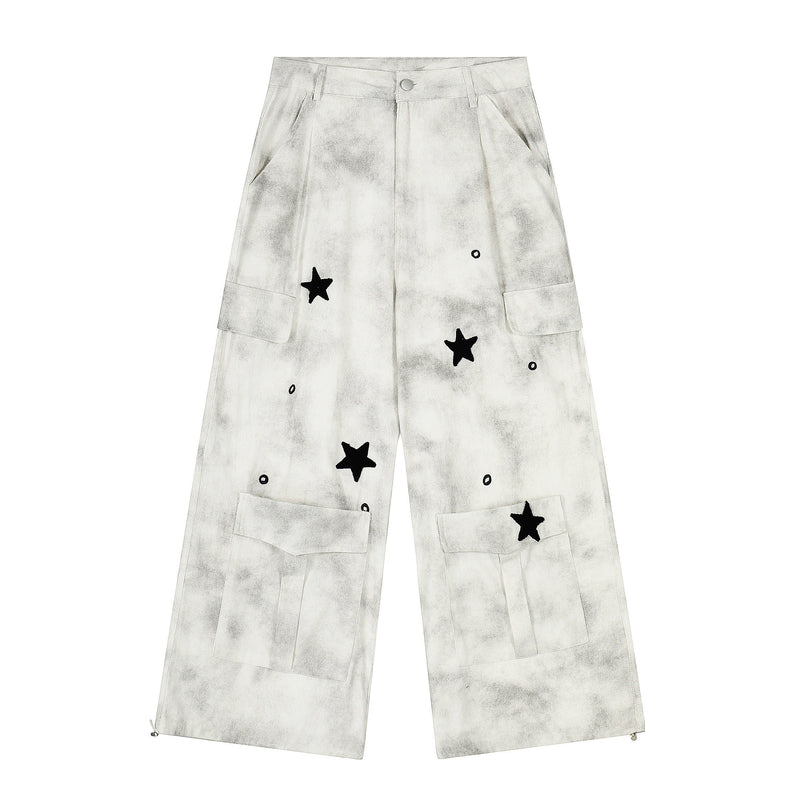 Front view of white washed cargo wide-leg pants with black star patches and flap pockets