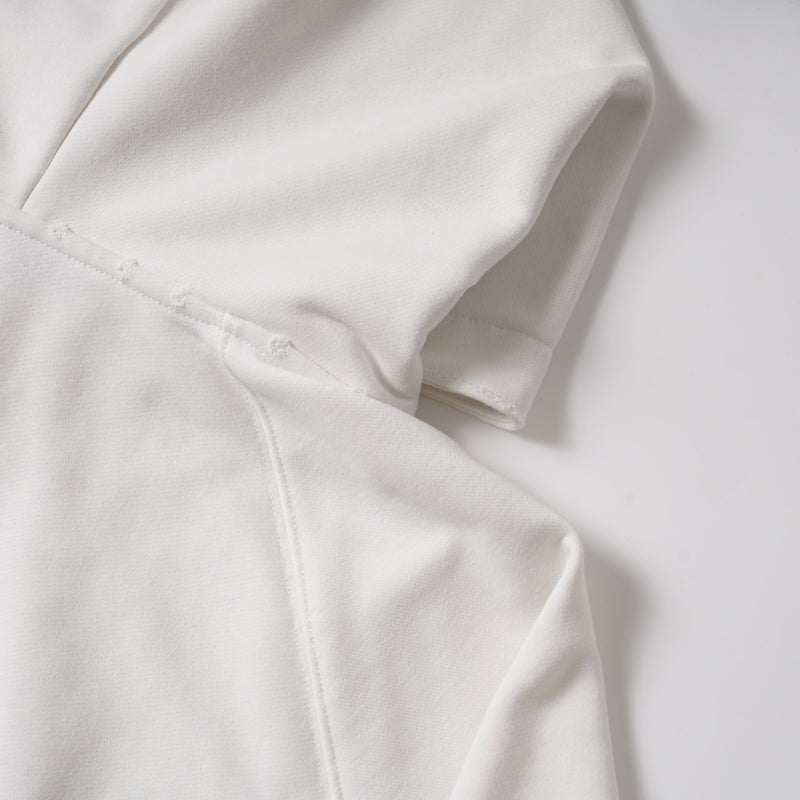Close-up of white hoodie sleeve seam and stitching detail