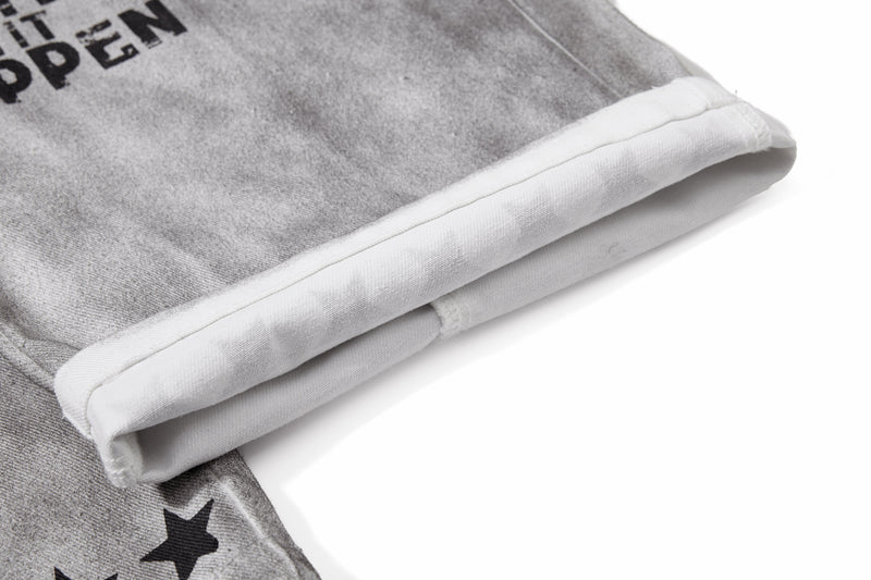 Close-up of folded pant hem showing white inner lining on gray washed denim