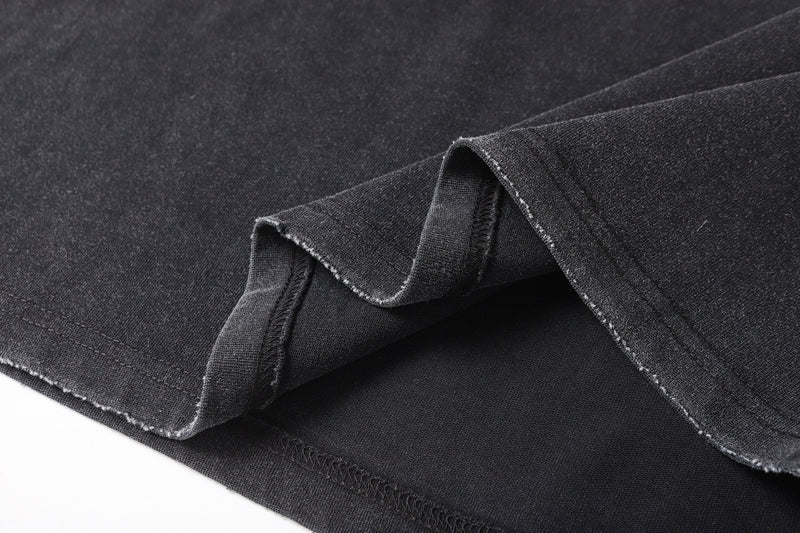 Close-up of layered hem with raw edges and black underlayer