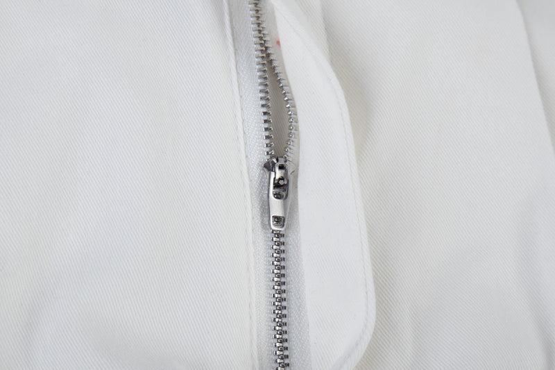 Close-up of white cargo pants zipper fly with silver metal zipper