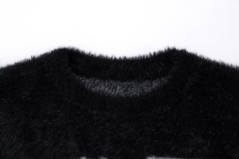 Close-up of the black fuzzy sweater neckline and plush knit texture