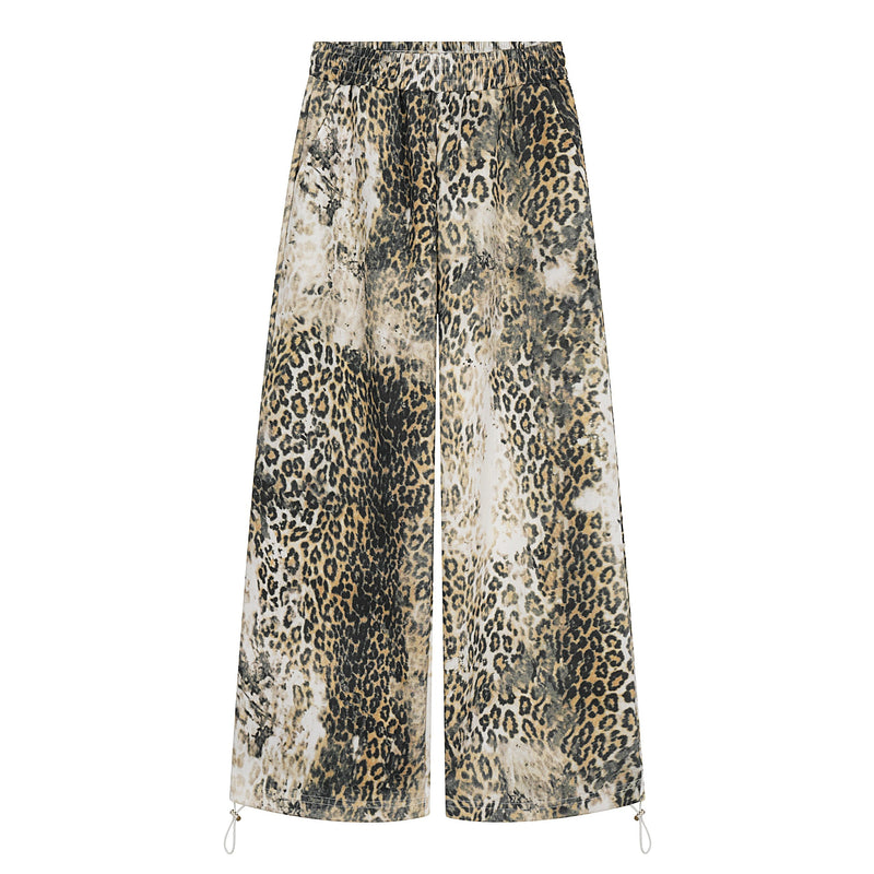 Front view of wide-leg leopard print pants with elastic waistband and drawcord hems