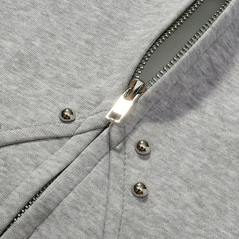 Gray zip hoodie close-up of front zipper and studded seam intersection