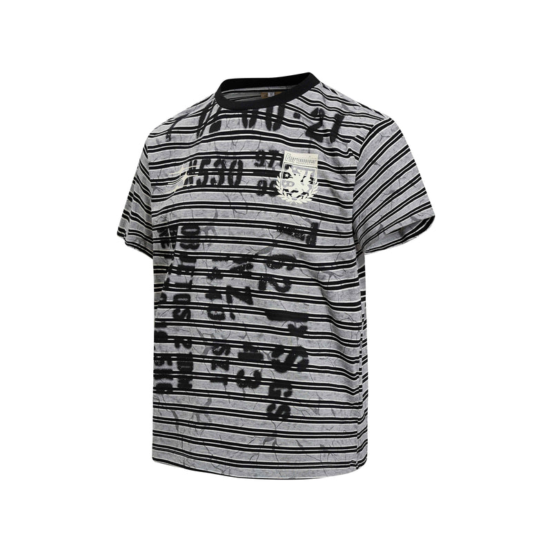 Black and gray striped streetwear T-shirt with graffiti-style print and chest crest on a white background