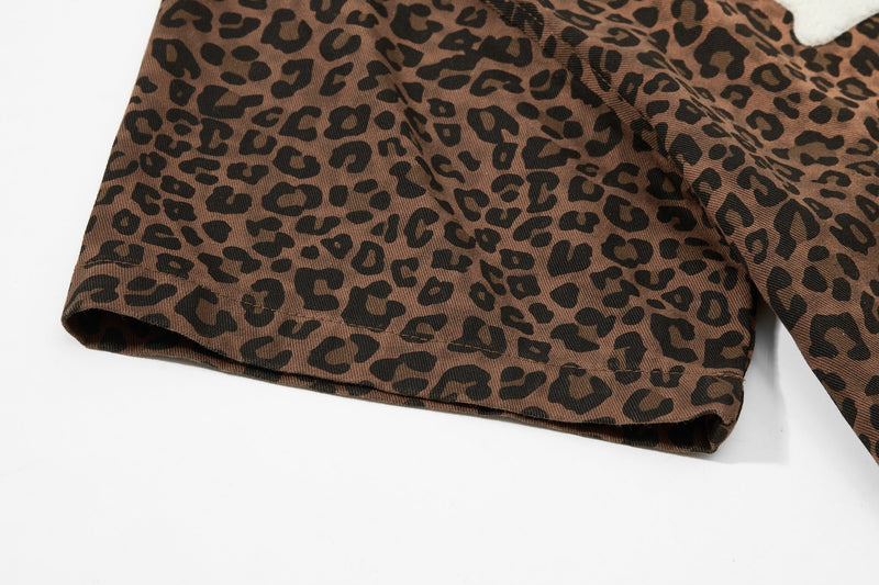 Brown leopard print shirt with rolled cuff and bold all-over animal pattern on a white background