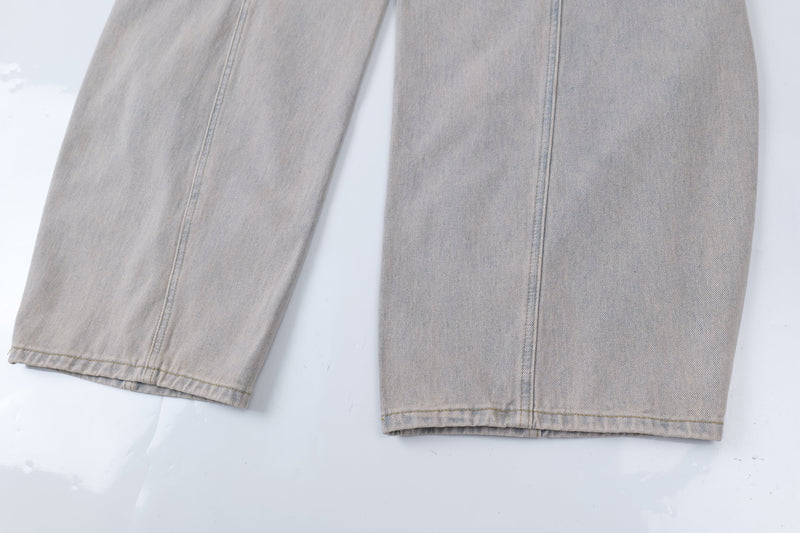 Close-up of straight hem and side seams on light wash wide-leg jeans