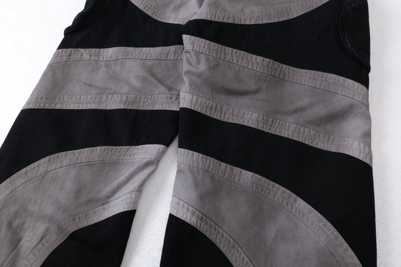 Close-up of the lower leg panels showing gray bands over black fabric on cargo pants