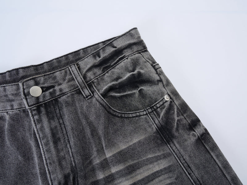 Close-up of grey denim waistband and front pocket with snap button detail