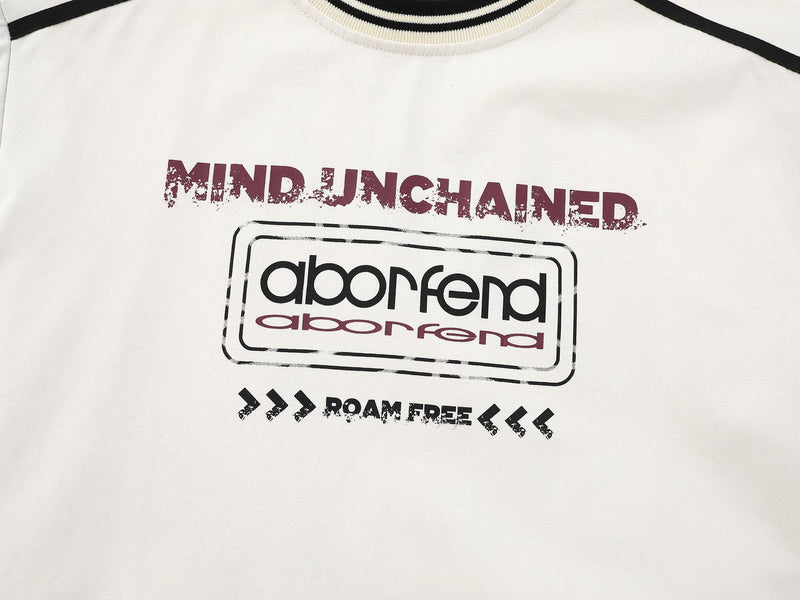 Close-up of cream tee front graphic reading mind unchanged, aborfend and roam free