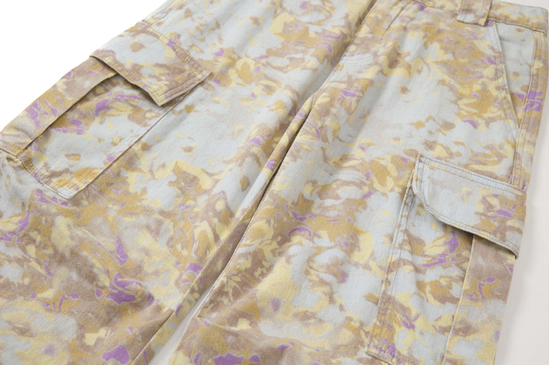 Diagonal front view of abstract camo cargo pants showing the left leg and side pocket