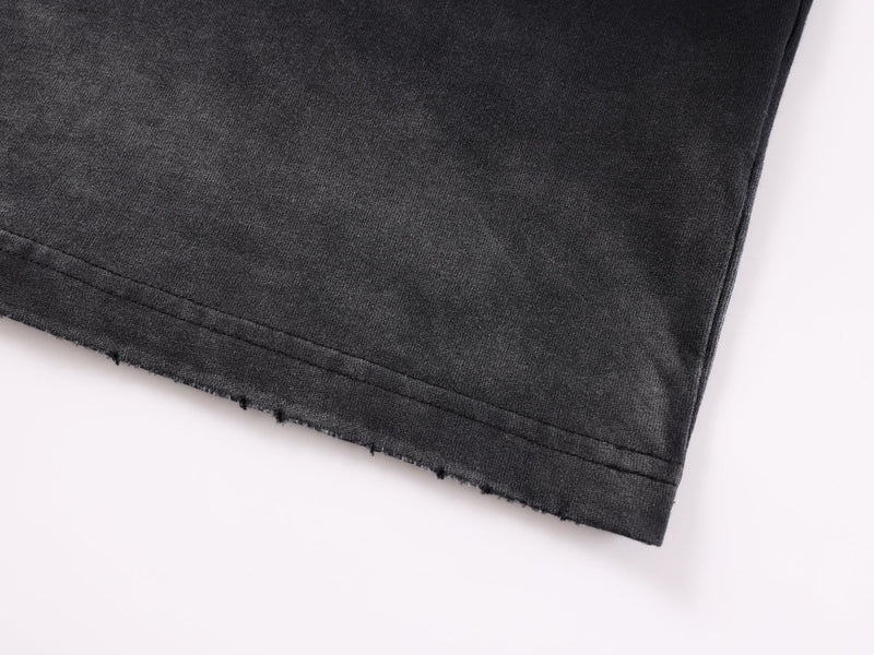 Close-up of black hem with raw edge and stitched finish