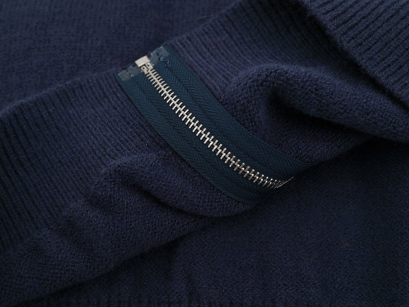 Close-up of side pocket zipper on the navy knit jacket