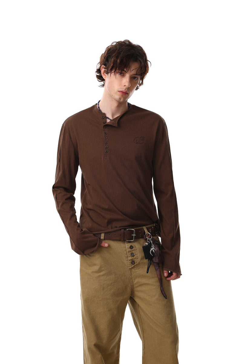 Model wearing brown Henley long sleeve T-shirt, front view
