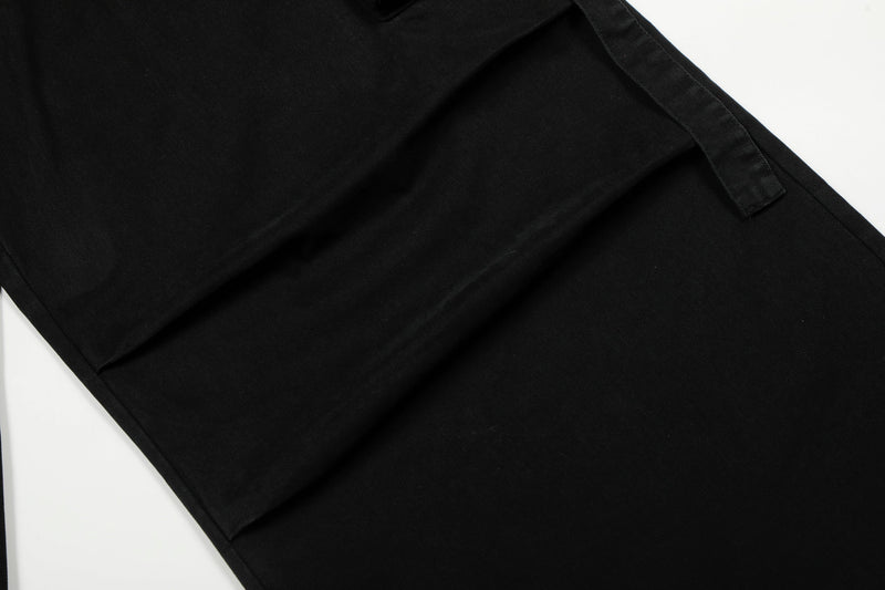 Close-up of plain black pant leg showing smooth fabric and wide hem