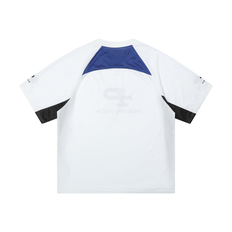 White colorblock sport jersey tee with blue yoke and black sleeve accents on a clean background