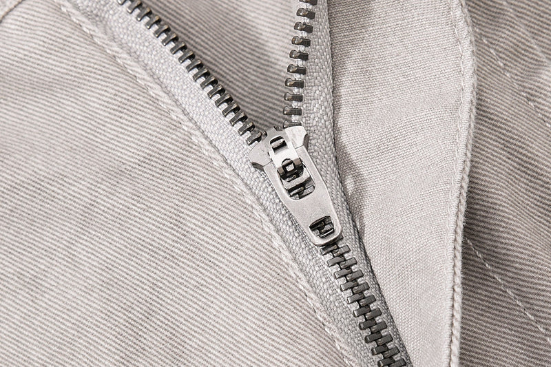 Close-up of light beige denim zipper and inner waistband seam