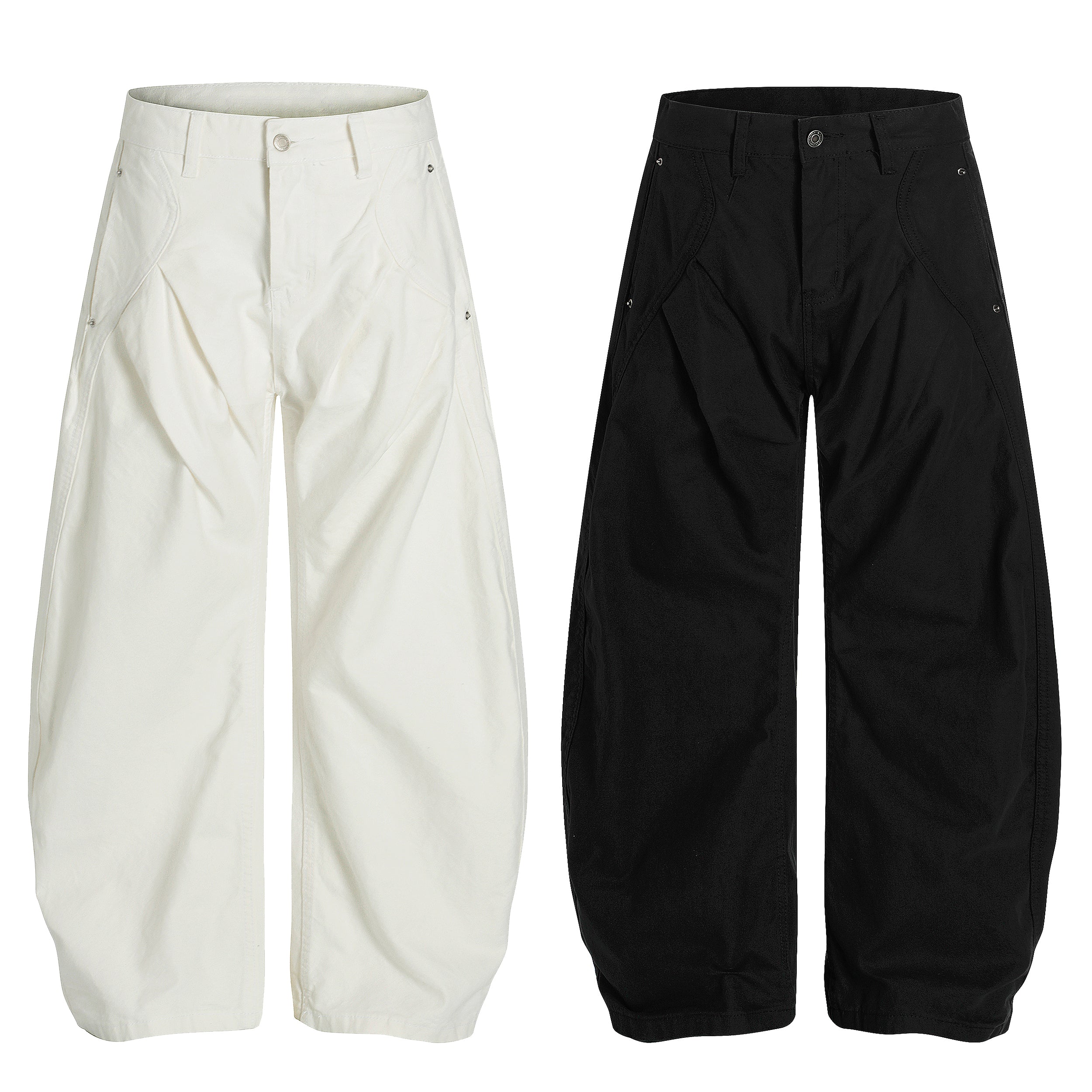 Omirad sculpted wide-leg cotton pants in off-white and black, shown flat with curved panel seams and metal rivet detailing
