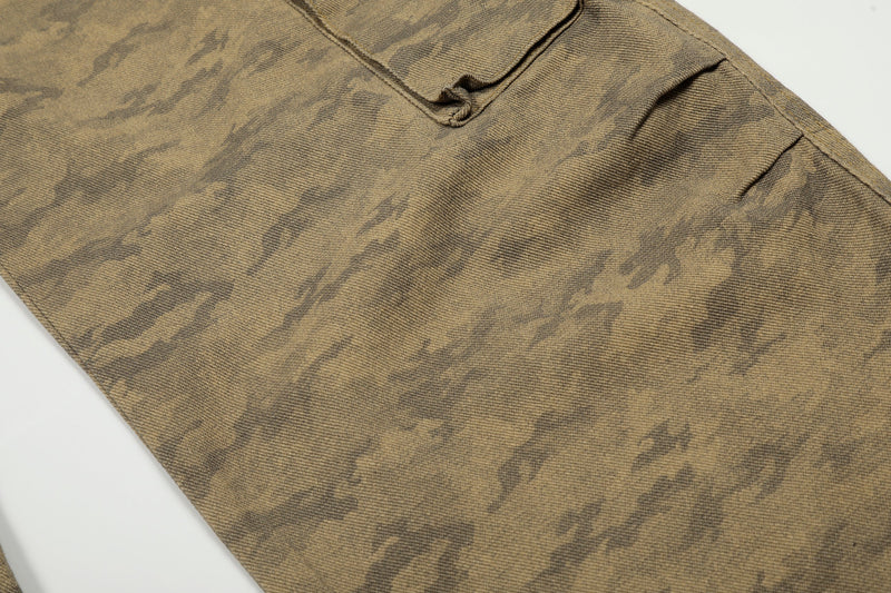 Close-up of camo denim fabric and cargo pocket seam on the jeans