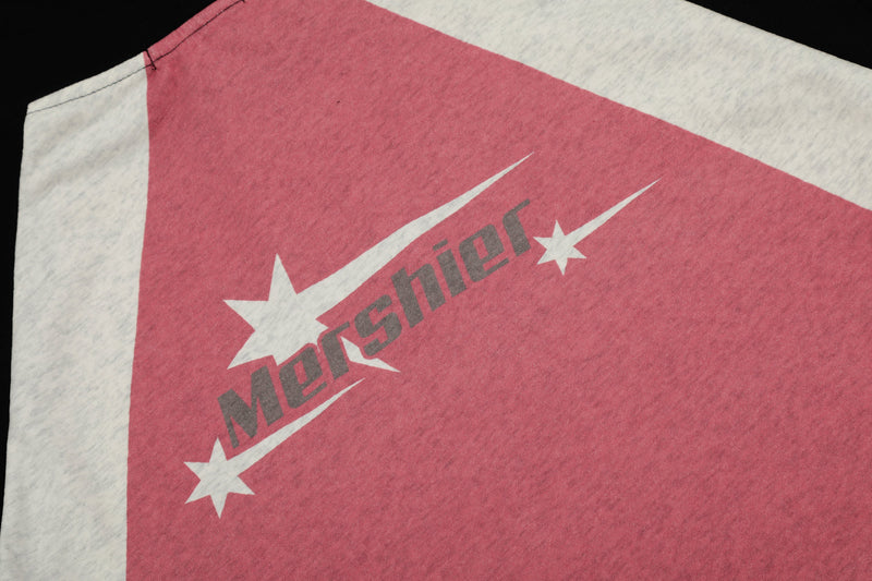 Close-up of pink panel on hoodie showing angled Mershier logo and star print