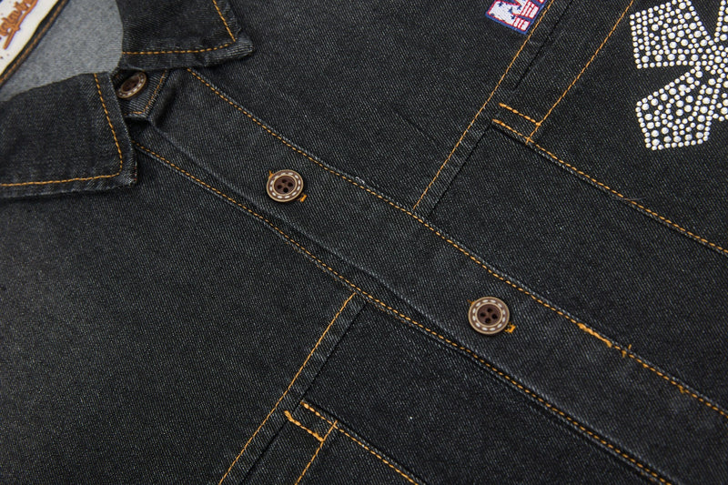 Close-up of a black denim button-up shirt with contrast stitching and rhinestone cross detailing on the chest