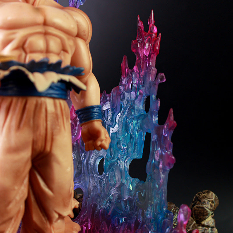 Close-up of a Seakoff Goku Ultra Instinct Collectible Figure, 35cm, showcasing muscular features in a blue and beige outfit. He stands before a vibrant backdrop with blue, pink, and purple hues resembling energy or crystals.