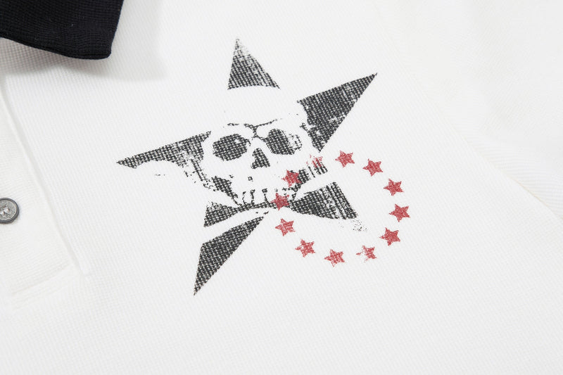 White polo shirt with a bold gothic skull and star graphic in black and red