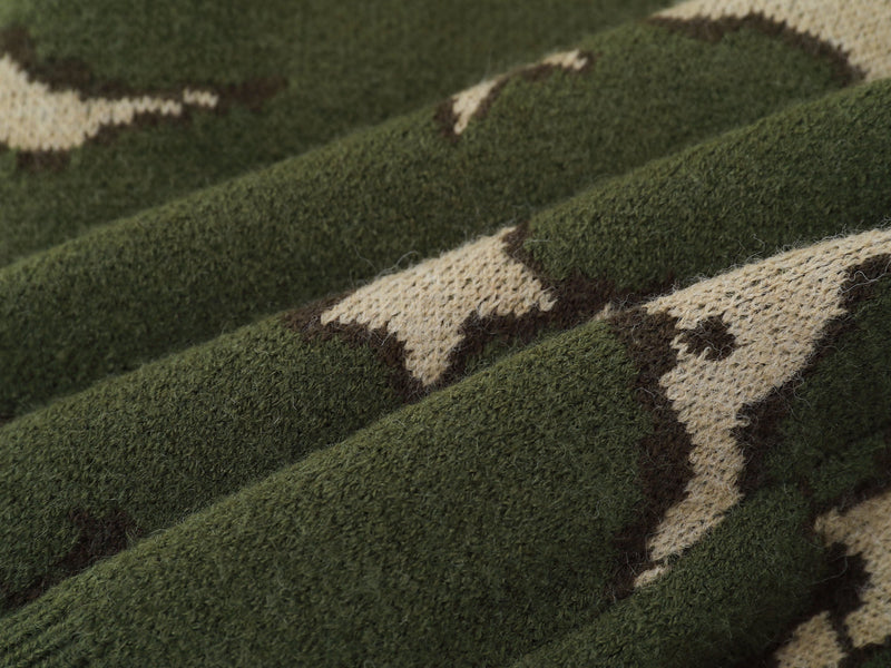 Close-up of green and cream camouflage knit texture on the sweater