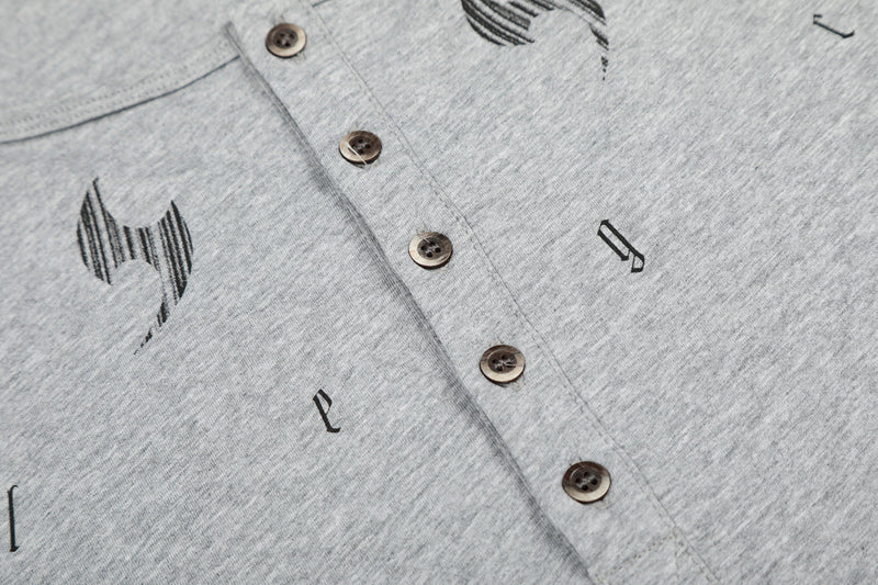 Gray henley close-up of button placket and chest graphics