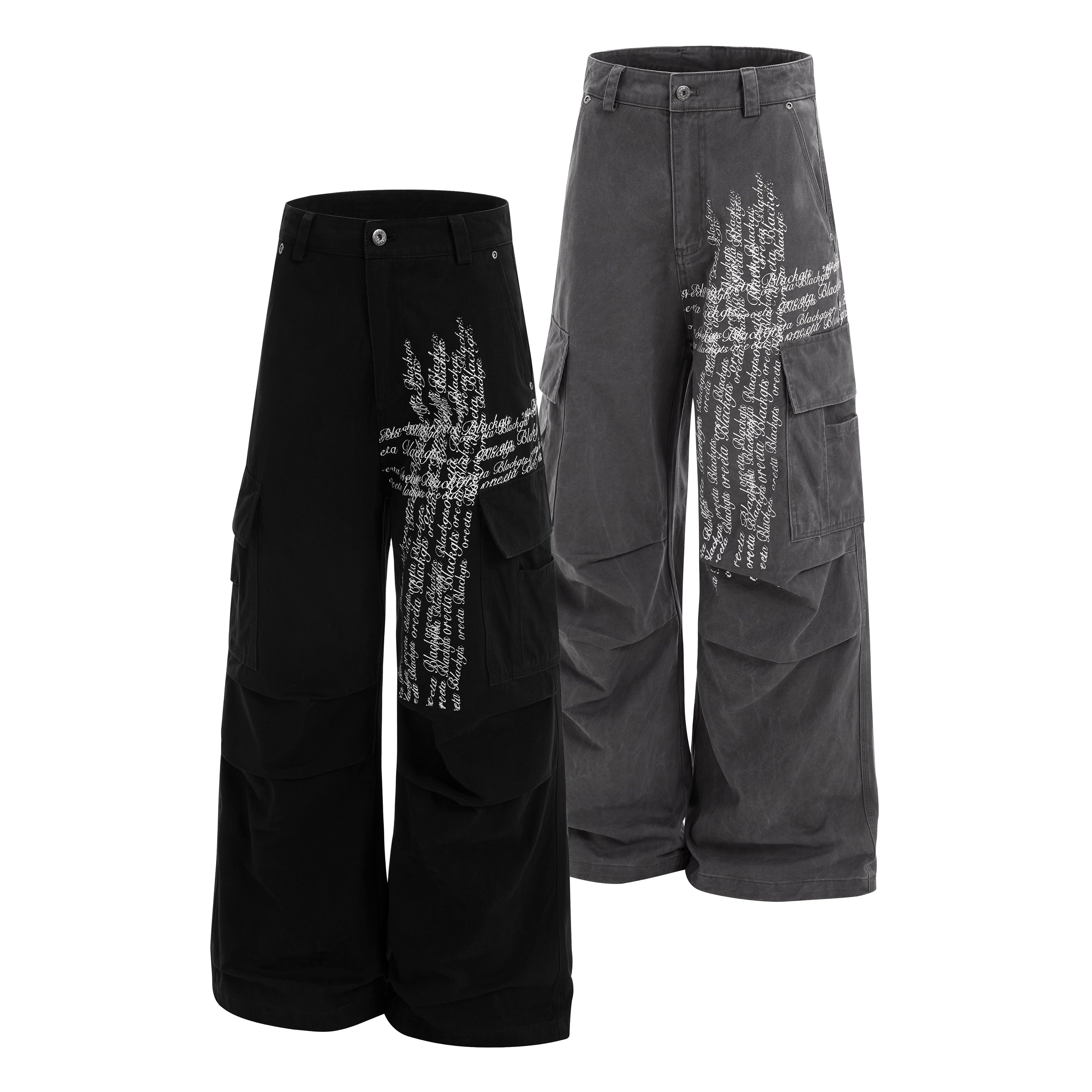 Omirad cross script cargo pants in washed black and charcoal grey, wide leg relaxed fit with cursive lettering print
