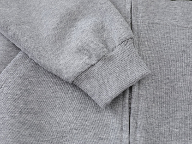Close-up of gray hoodie ribbed cuff and front zipper seam