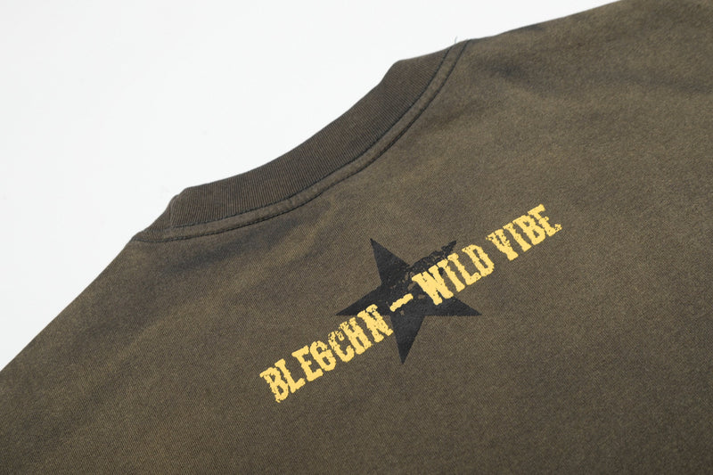 Vintage washed olive graphic T-shirt with a black star and yellow Wild Vibe print on the back neckline