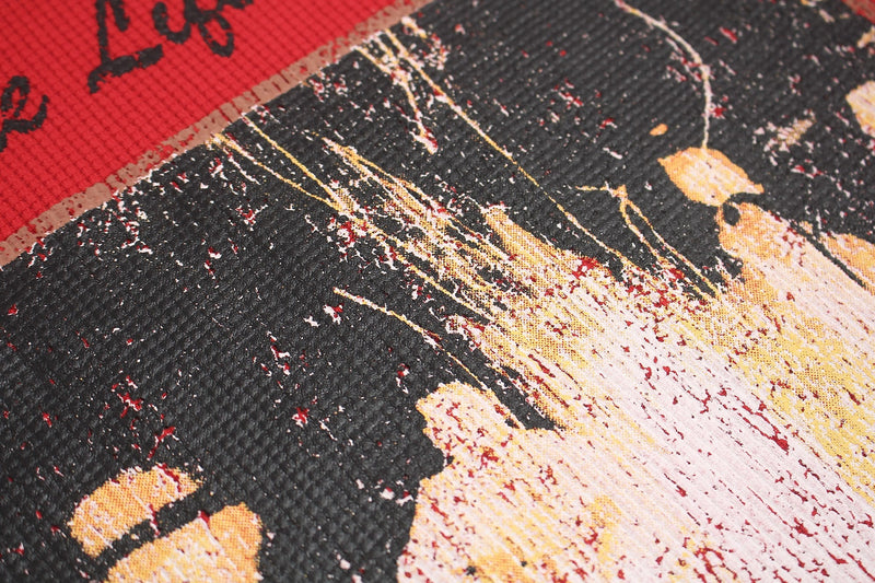 Close-up of a distressed punk graphic tee print with black, red, and yellow splattered paint textures