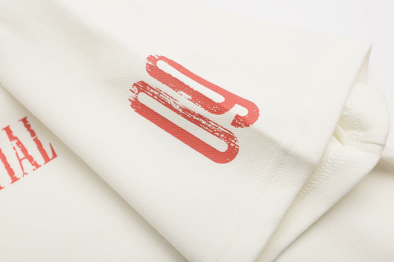 Close-up of cream polo shirt fabric with red graphic print and stitched collar detail, Y2K streetwear style