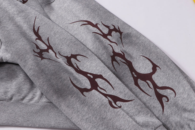 Close-up of gray sleeve with dark tribal-style print