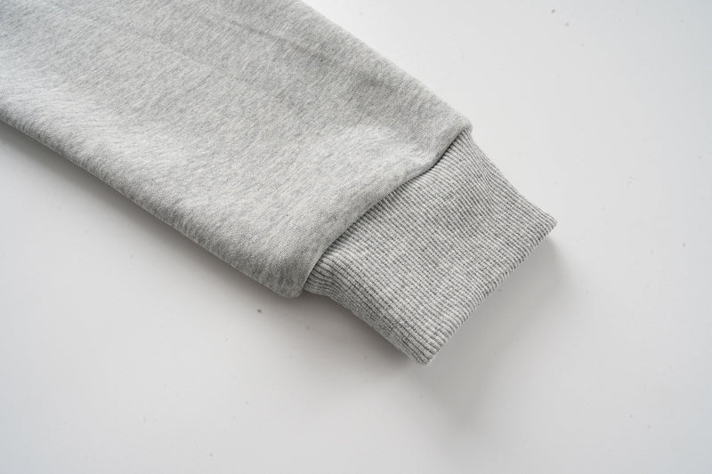Heather grey hoodie sleeve cuff close-up with ribbed knit wristband
