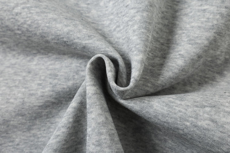 Close-up of light gray hoodie fabric with twisted knit texture