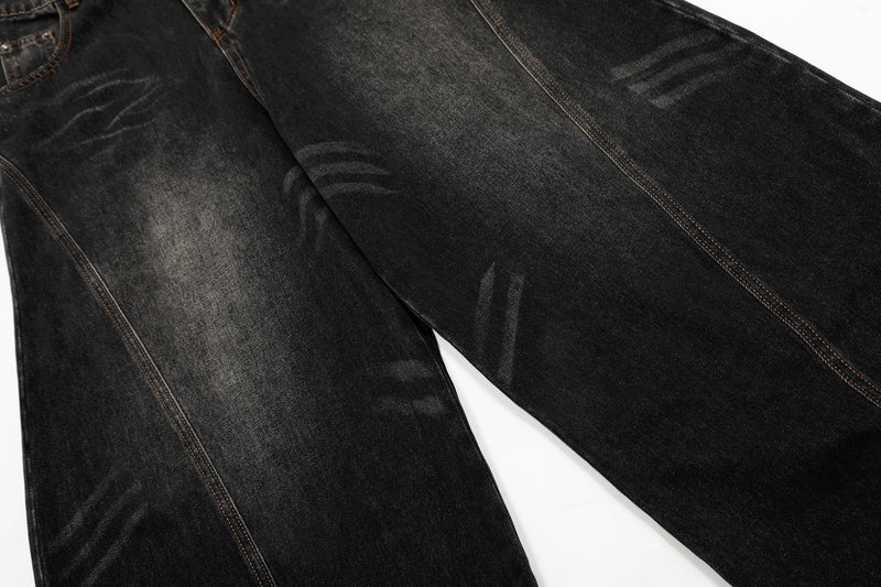 Close-up of black vintage wash denim fabric and seam stitching