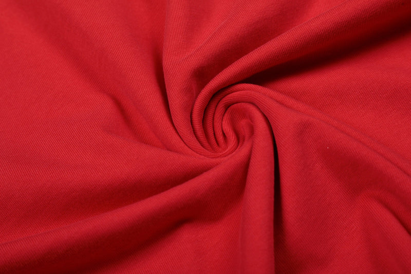 Red distressed graphic tee fabric detail with soft cotton folds and a vintage streetwear look