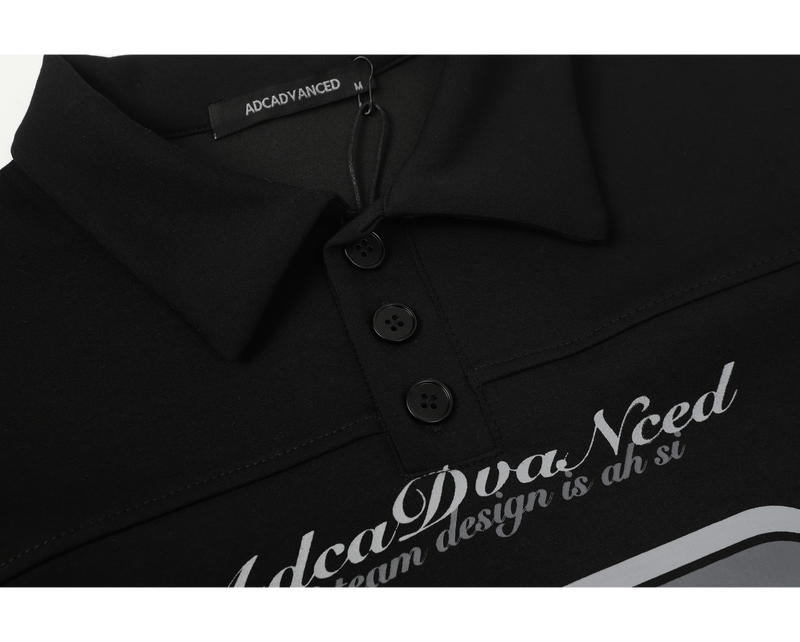 Close-up of black polo collar, three-button placket, and chest script print