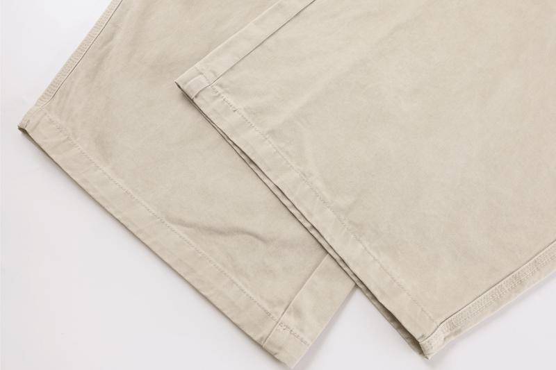 Close-up of beige cargo pants straight hem and lower leg seam