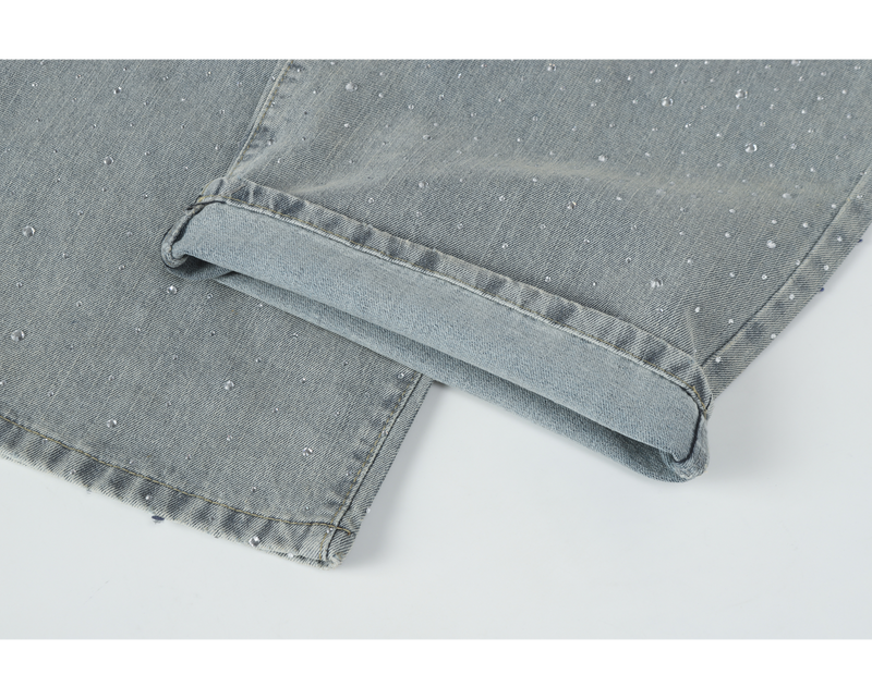 Rolled cuff hem on light-wash rhinestone wide-leg jeans