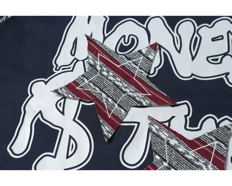 Close-up of navy graphic T-shirt with bold white lettering and red plaid patchwork star detail