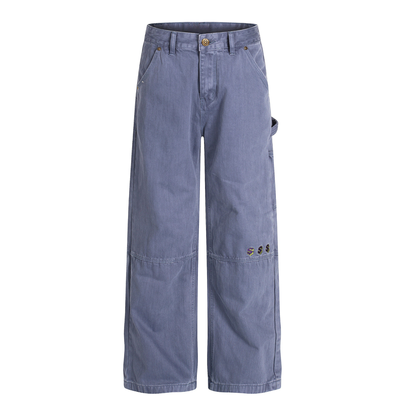 Front view of blue wide-leg carpenter pants with brass button and embroidered hem detail