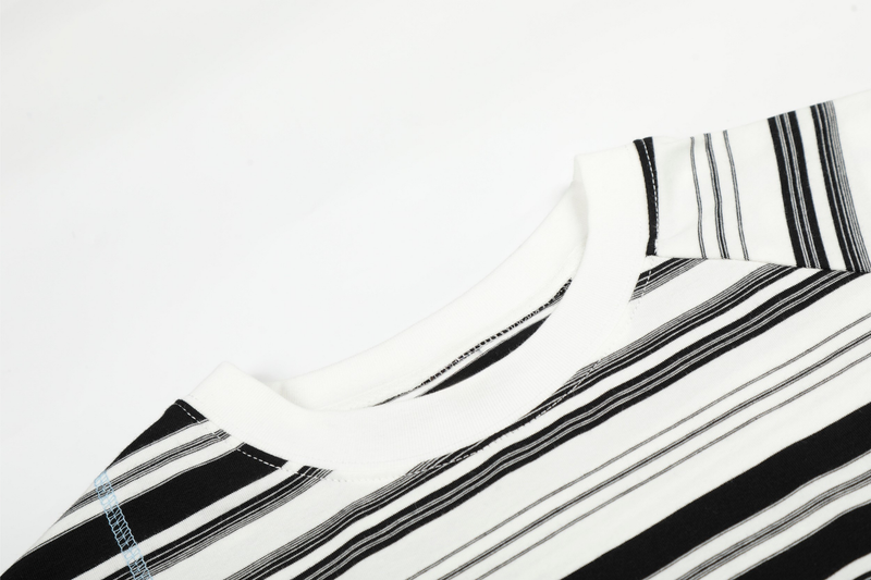 Close-up of black and white striped crewneck collar with white ribbed trim