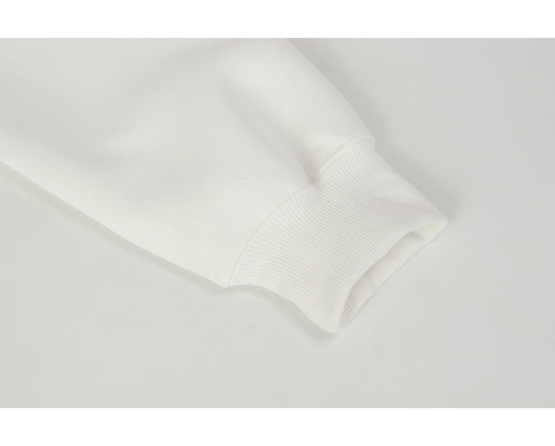 Close-up of white ribbed sleeve cuff on the hoodie