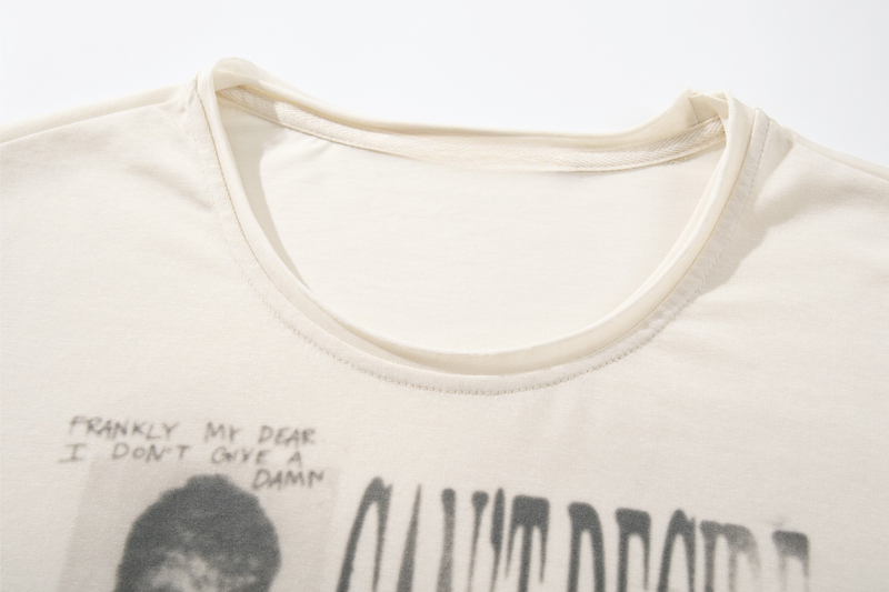 Close-up of crew neckline on cream long sleeve tee with printed chest graphic