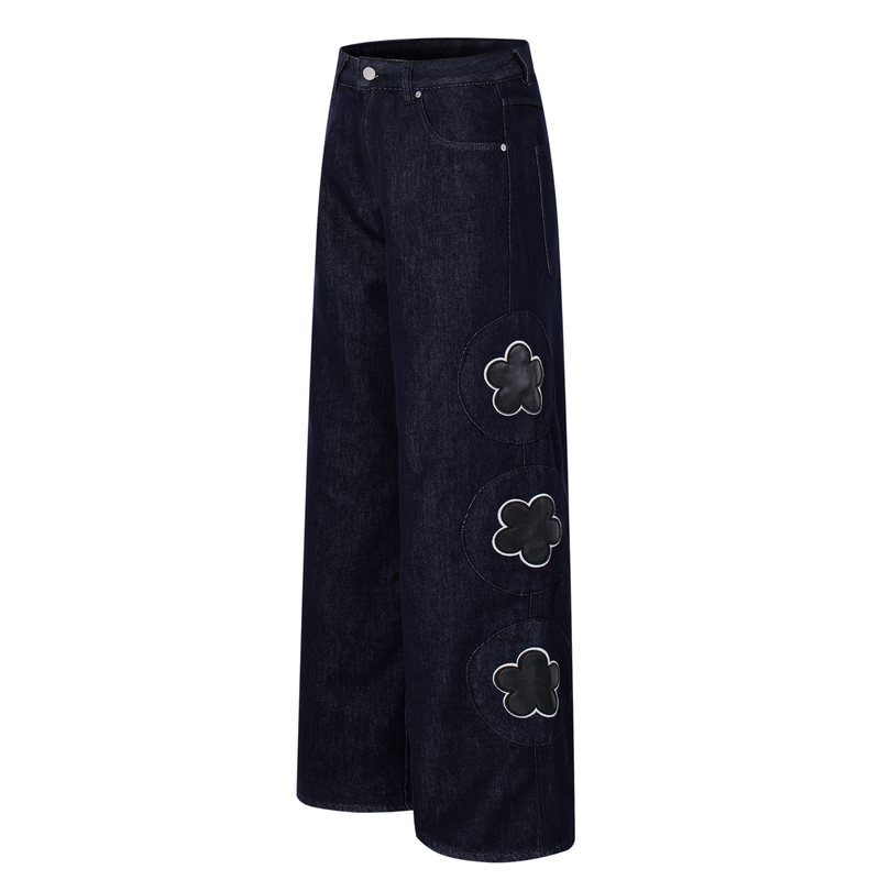 Dark wash wide-leg jeans with floral patch details on the side, angled front view