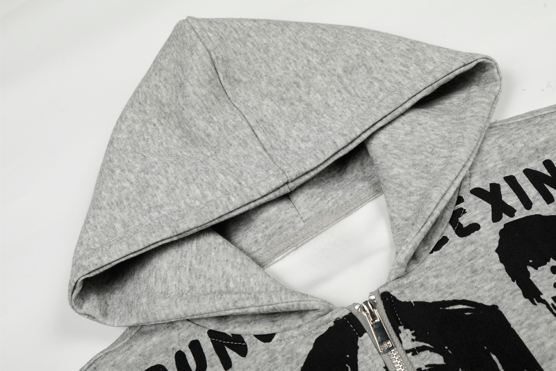 Close-up of light gray hoodie hood and shoulder with front graphic edge