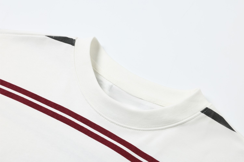 Close-up of white mock neck collar and striped shoulder seam
